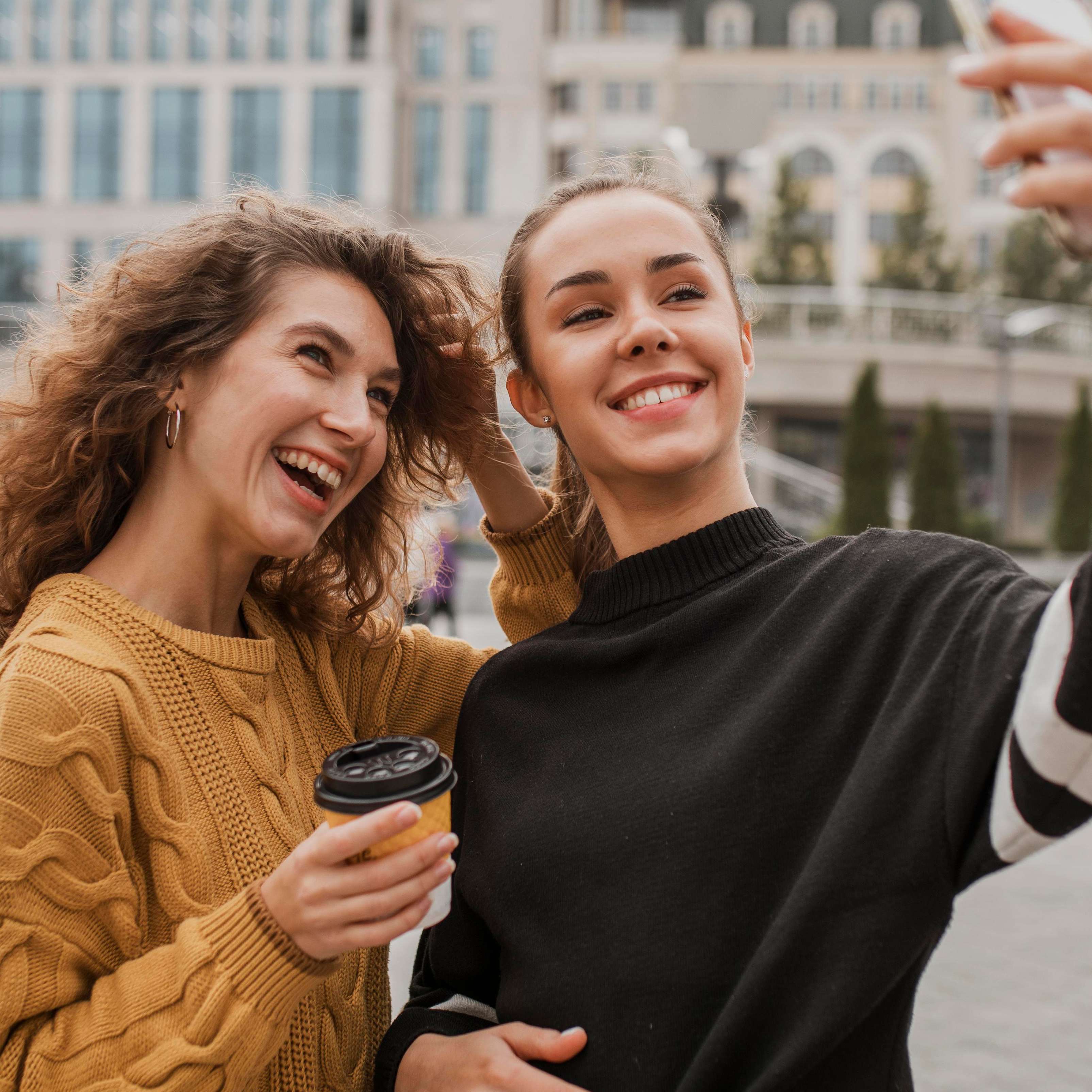 Best friends laughing and taking a selfie together