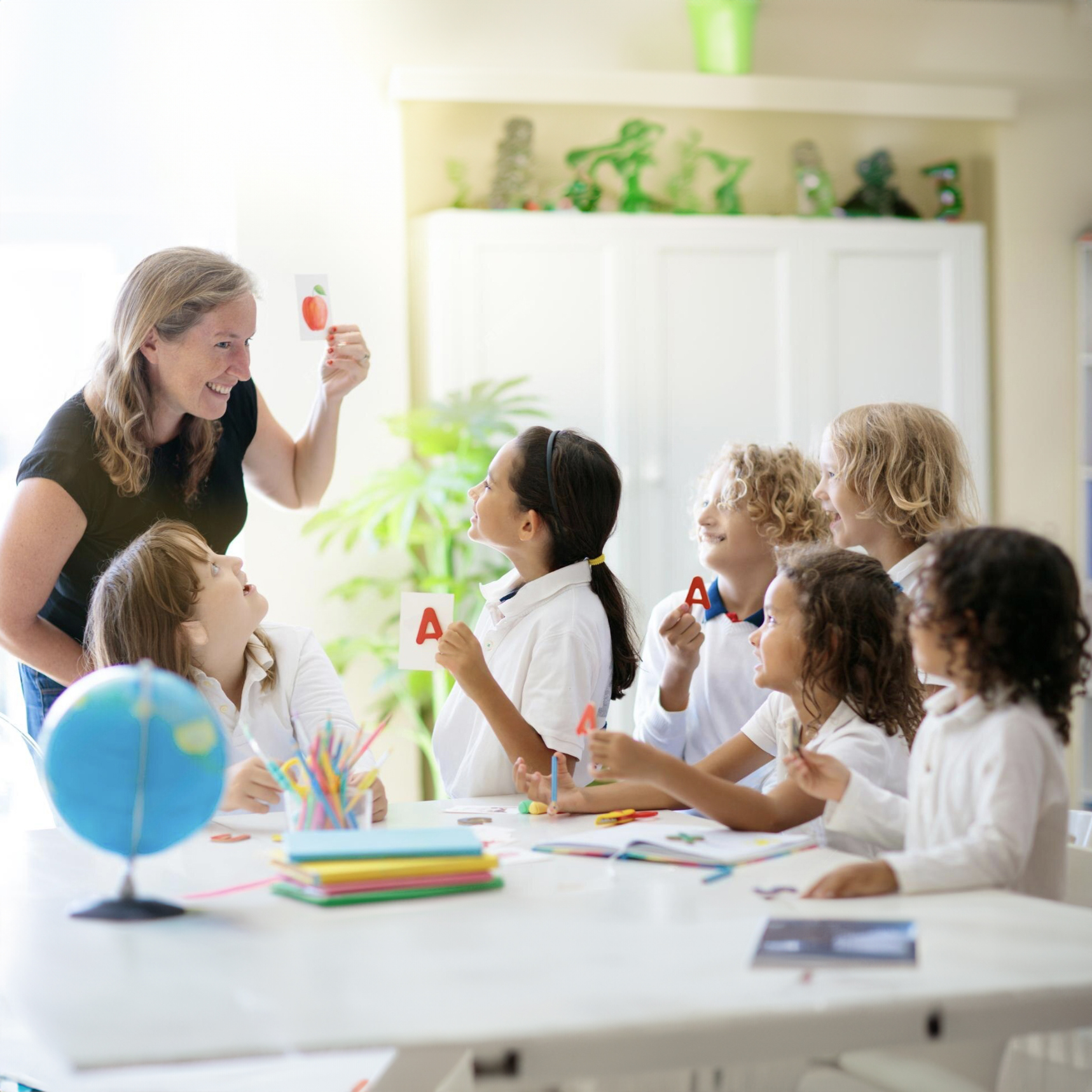 Teacher engaging with diverse group of children in classroom setting