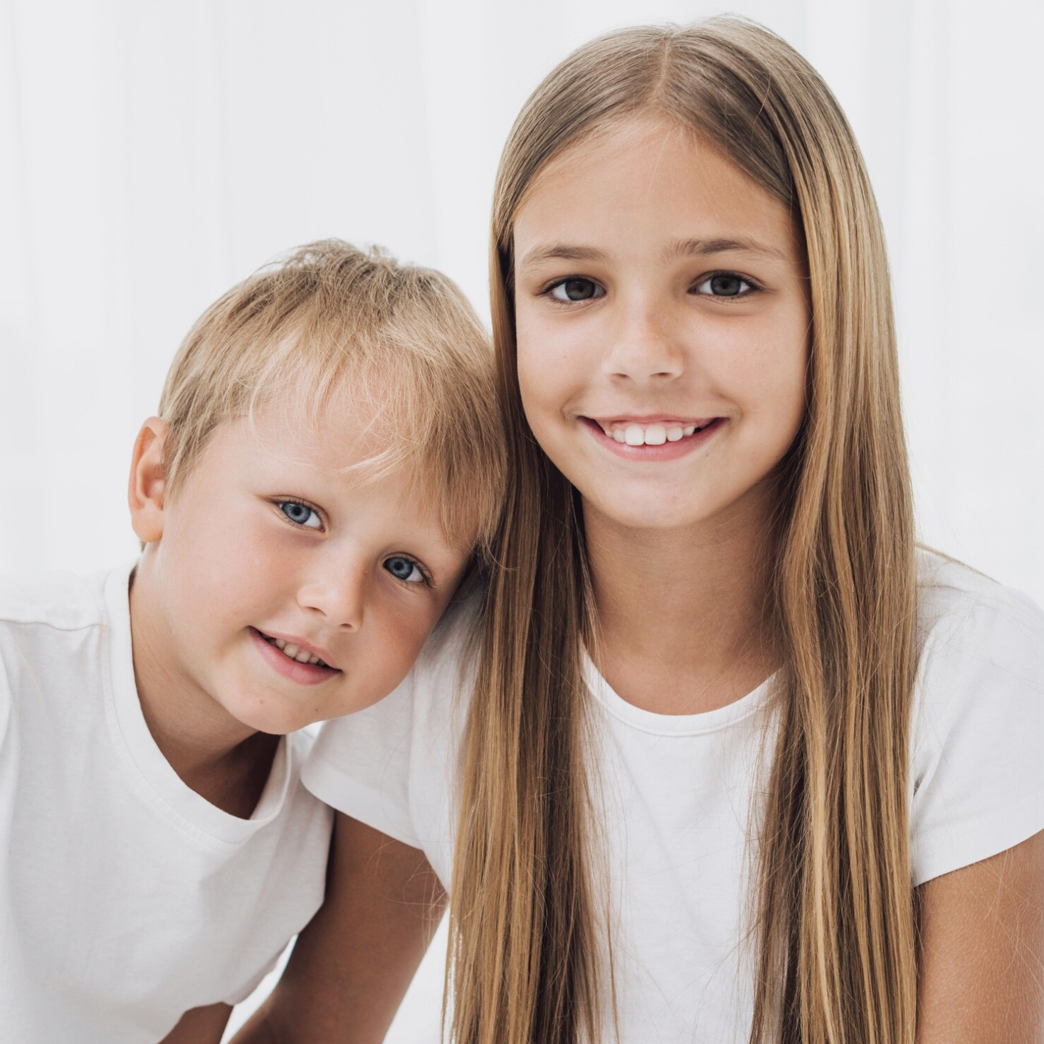 Happy siblings - brother and sister smiling together
